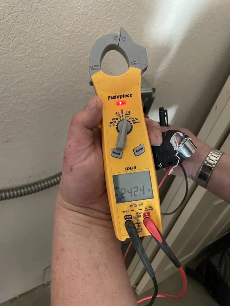 Voltage testing with clamp meter during Outlet Installation in Humble